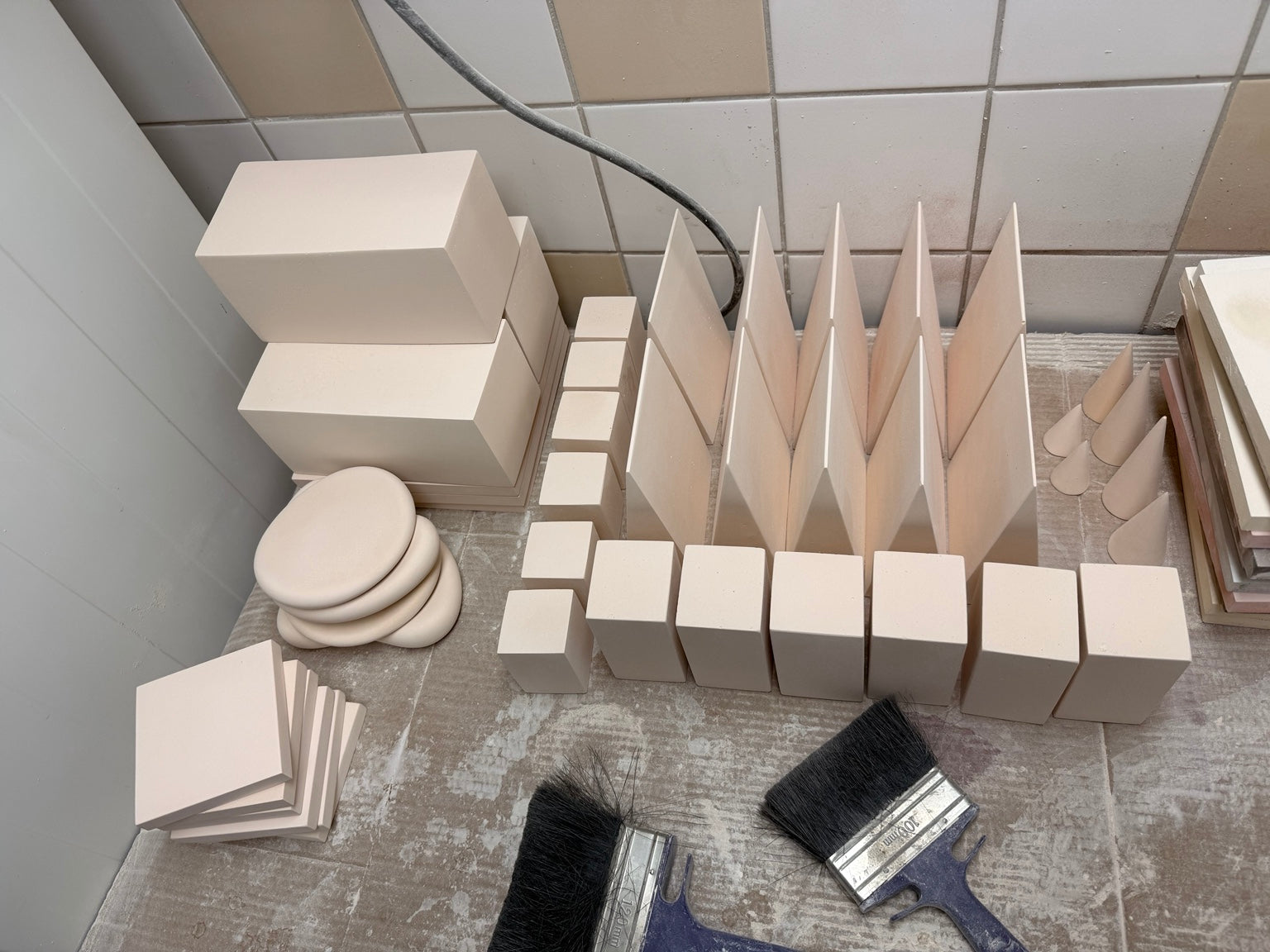 Coordinated pale mineral display set combining blocks, panels, discs and geometric forms