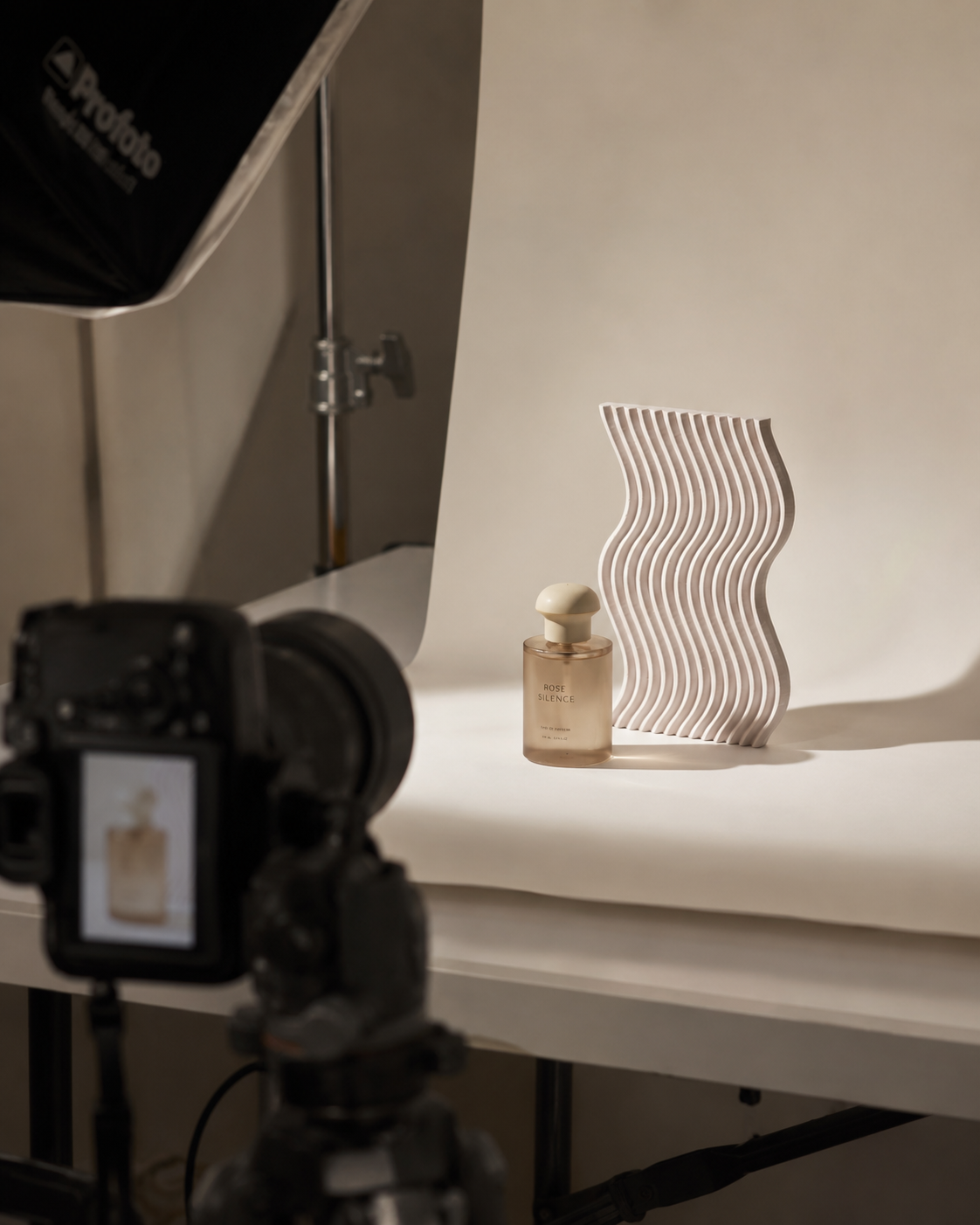 Behind the scenes product photography studio setup with Betonvton sculptural prop, camera and softbox