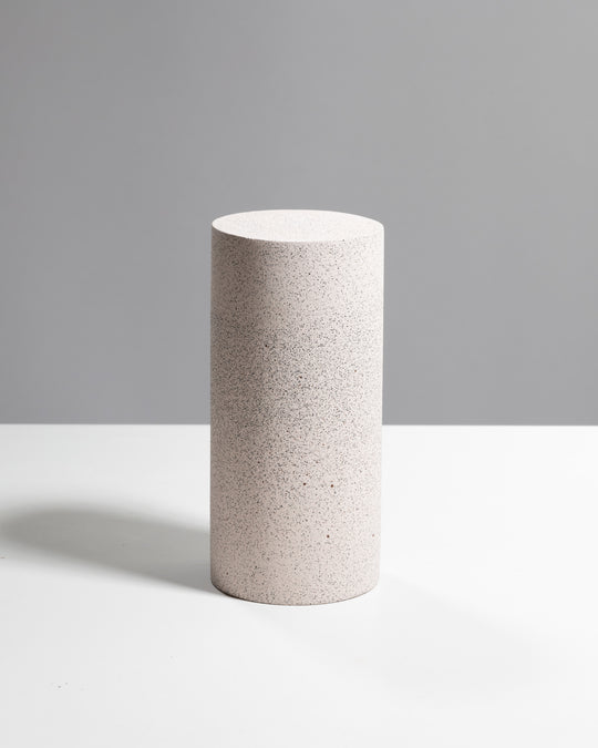 Dusty pink speckled concrete cylinder vase and display pedestal with black sand texture