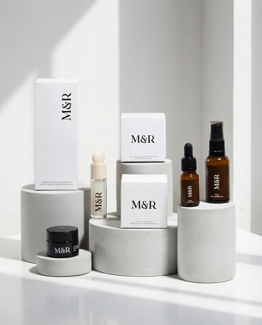 Minimal plaster cylinder risers styled with luxury skincare packaging for boutique retail presentation