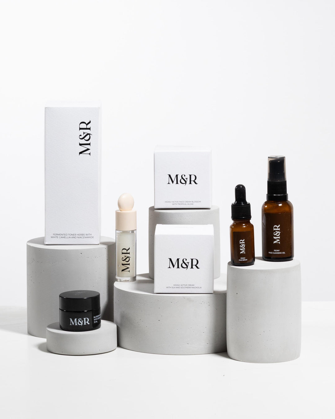Minimal skincare merchandising setup with plaster podiums and luxury cosmetic packaging
