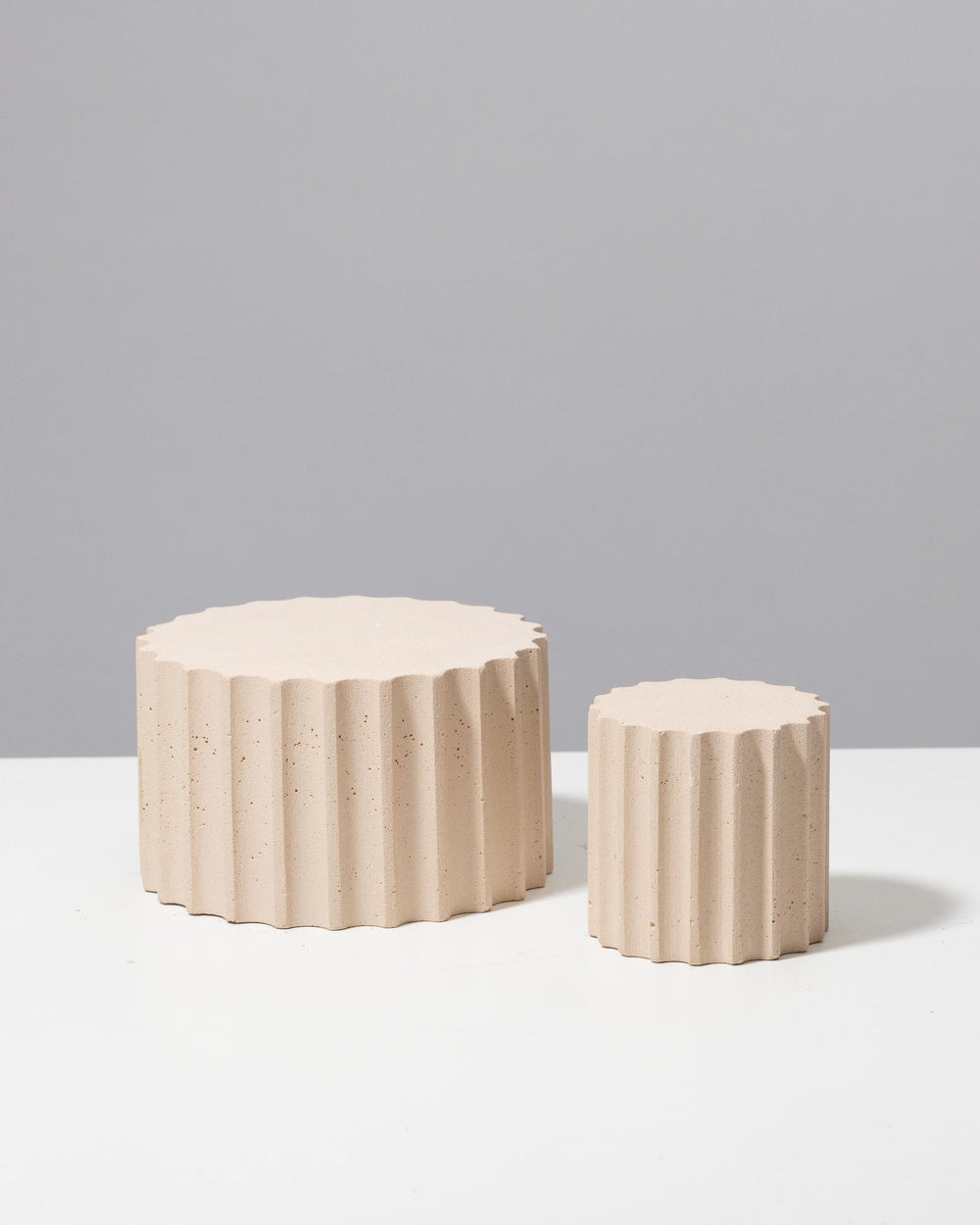 Speckled beige fluted display pedestals with flat tops for jewelry presentation