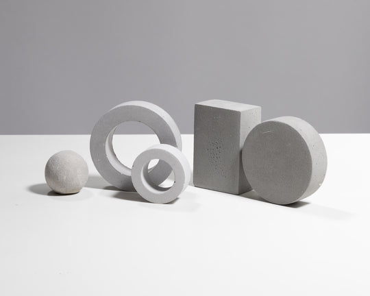 Light grey plaster prop set with sphere rings block and disc for product photography