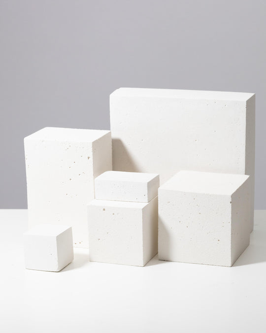 White textured display blocks of varying sizes arranged in a cluster