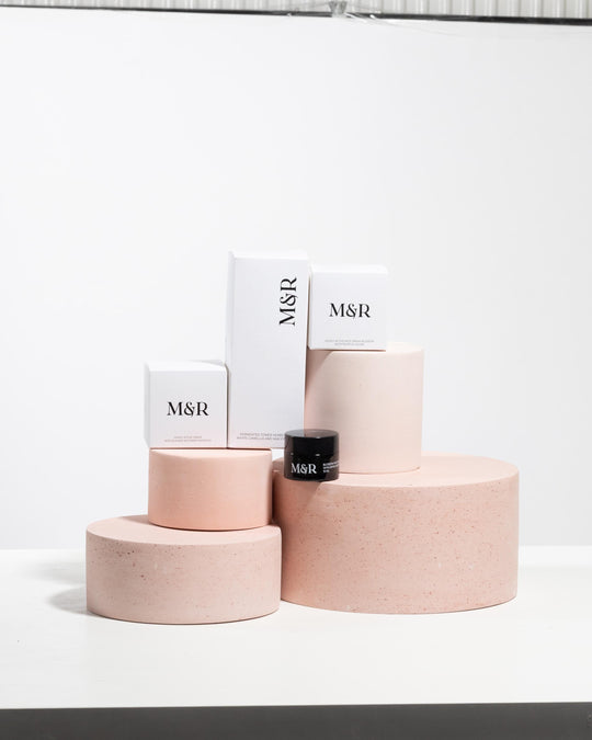 Pale pink PLV boutique display set styled with skincare packaging