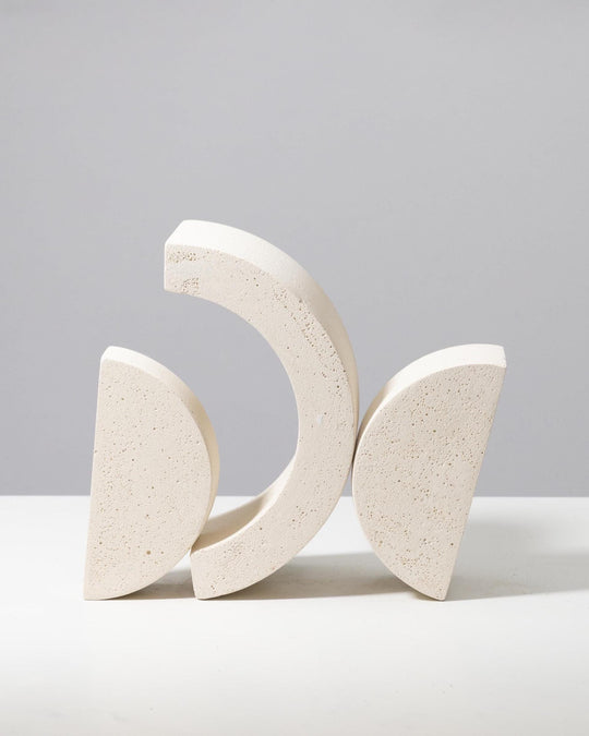 Off white plaster riser set with nested arch and half circle shapes, porous mineral texture