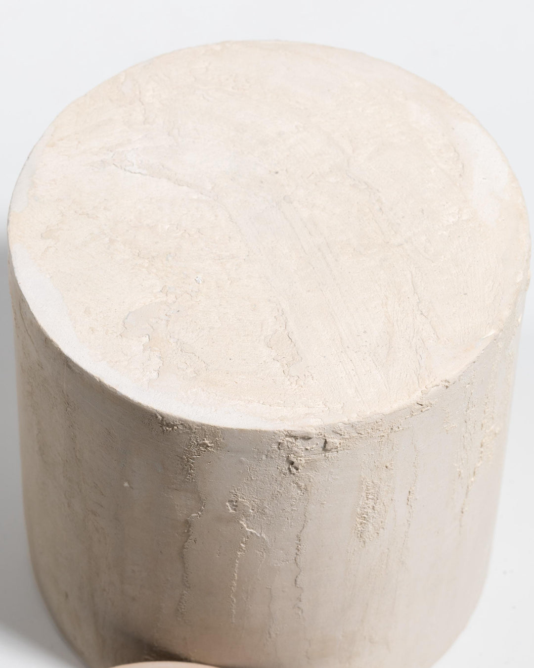 Close view of the striated matte texture of the beige cylinder